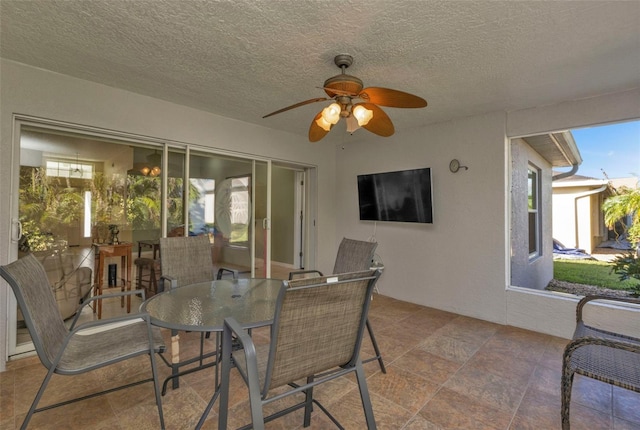 exterior space featuring ceiling fan