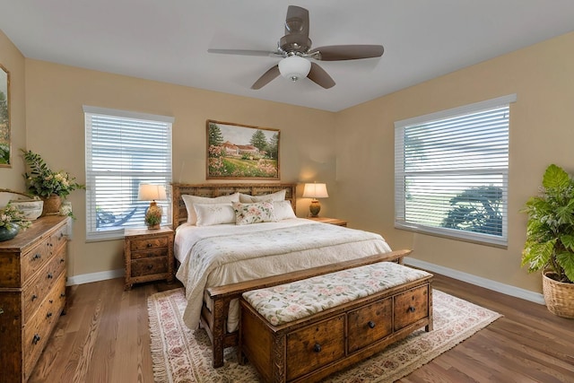 bedroom with ceiling fan and dark wood-type flooring