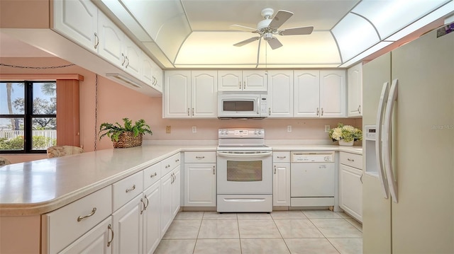 kitchen with light tile patterned floors, ceiling fan, white appliances, and light countertops