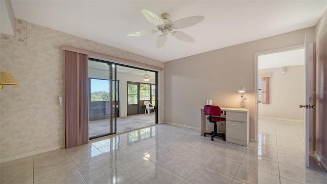 spare room with ceiling fan and light tile patterned floors