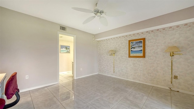 tiled spare room with ceiling fan