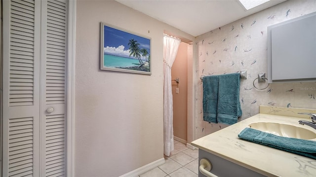 bathroom featuring tile patterned flooring and vanity