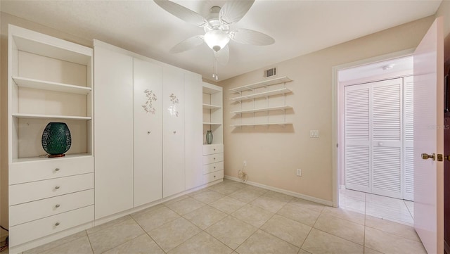 unfurnished bedroom featuring ceiling fan and light tile patterned floors