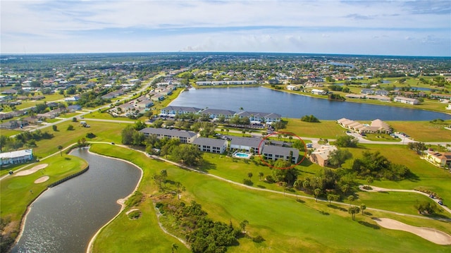 drone / aerial view featuring a water view, a residential view, and golf course view