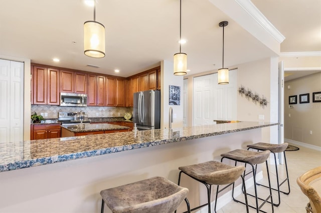 kitchen with hanging light fixtures, tasteful backsplash, dark stone counters, appliances with stainless steel finishes, and ornamental molding