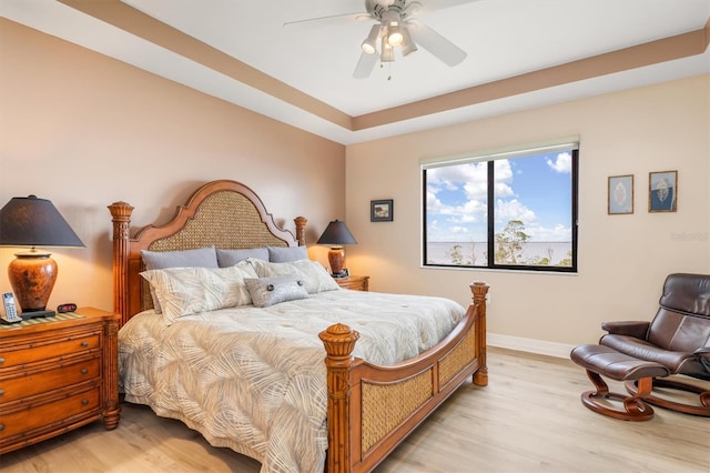 bedroom with ceiling fan and light hardwood / wood-style flooring