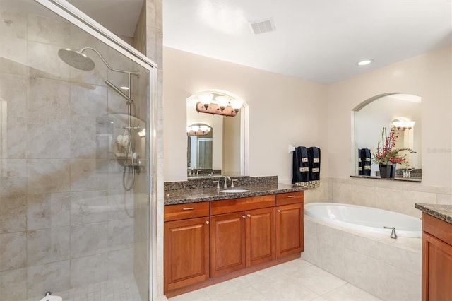 bathroom featuring tile patterned flooring, vanity, and separate shower and tub