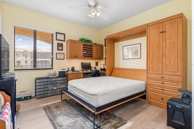 bedroom with ceiling fan and light wood-type flooring