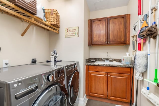 laundry room featuring cabinets, washer and clothes dryer, and sink