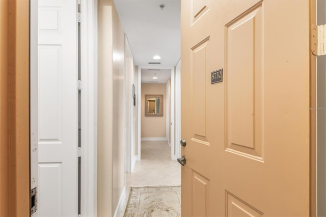 hall featuring light tile patterned floors