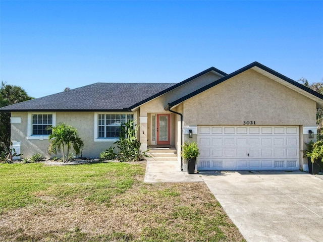 ranch-style house with a garage and a front lawn