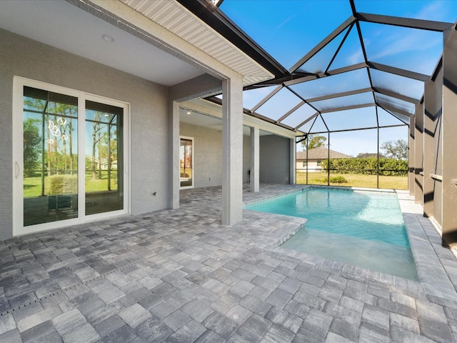 view of pool featuring a patio and glass enclosure