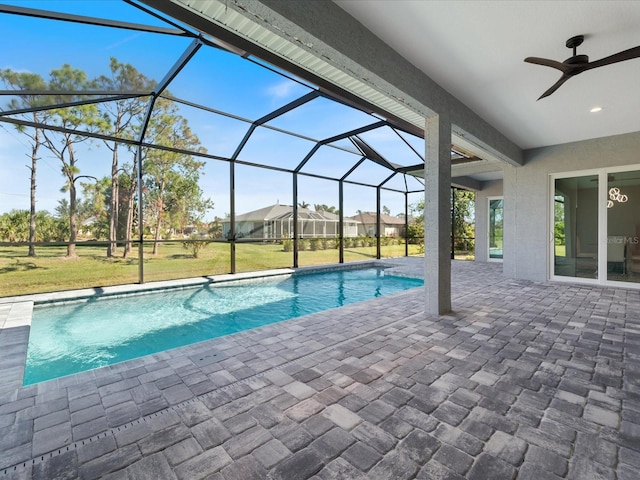 view of swimming pool with a patio, ceiling fan, and a lanai