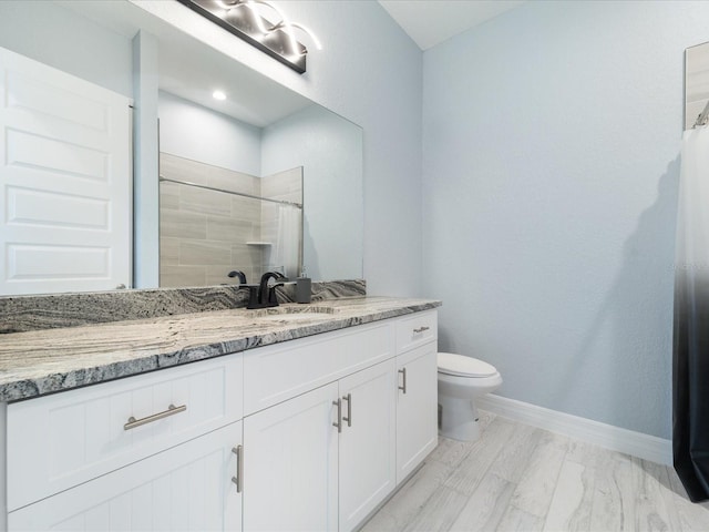 bathroom featuring hardwood / wood-style flooring, a shower with curtain, toilet, and vanity