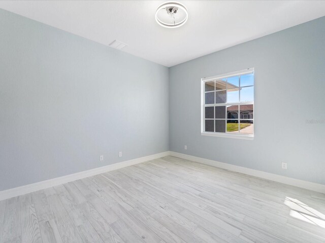 unfurnished room featuring light hardwood / wood-style floors