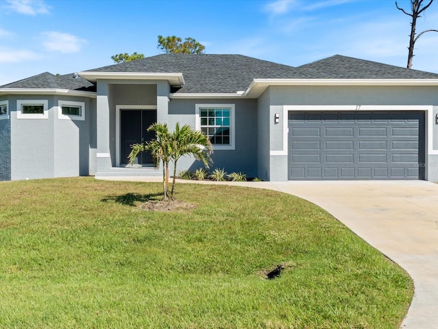 view of front facade featuring a front yard and a garage