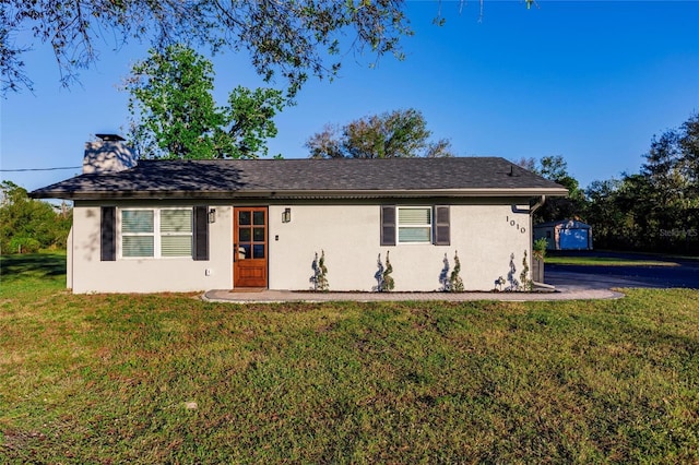 1010 Robinhood Dr, Punta Gorda, FL 33982 - ranch-style house with stucco siding, a front lawn, and a chimney