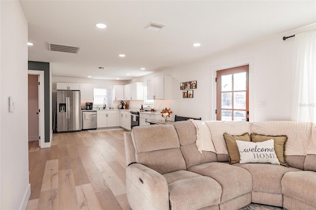 1010 Robinhood Dr, Punta Gorda, FL 33982 - living area with light wood-style flooring, recessed lighting, and baseboards