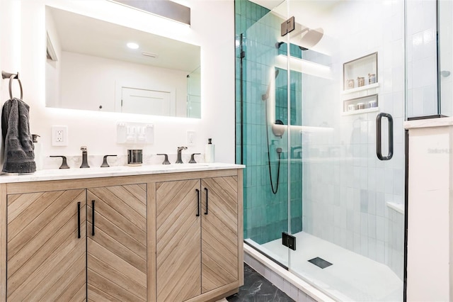 bathroom with vanity and a shower with door