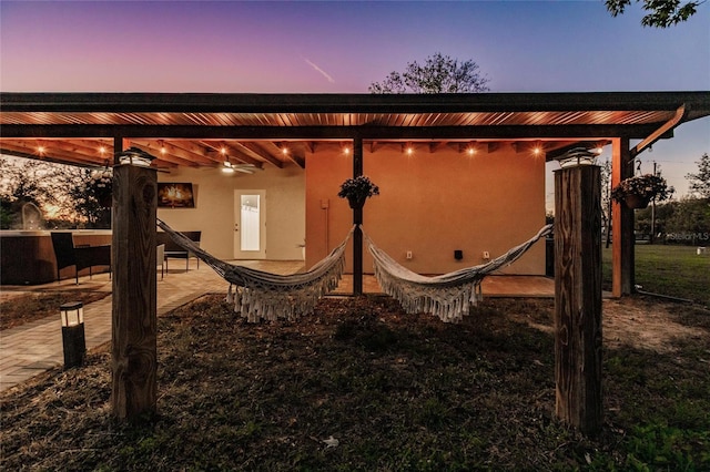 1010 Robinhood Dr, Punta Gorda, FL 33982 - back of property at dusk featuring stucco siding and a patio area