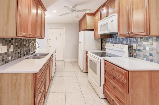 kitchen with backsplash, white appliances, and sink