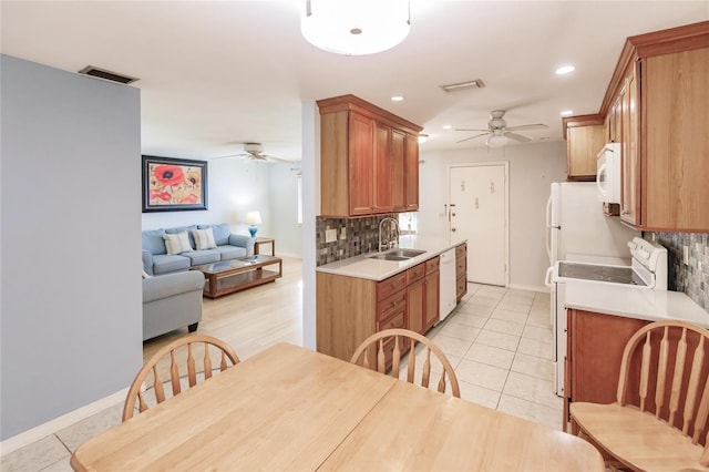 kitchen featuring white appliances, backsplash, sink, ceiling fan, and light tile patterned floors