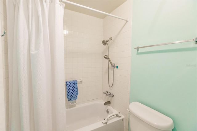 bathroom featuring shower / bath combo with shower curtain and toilet