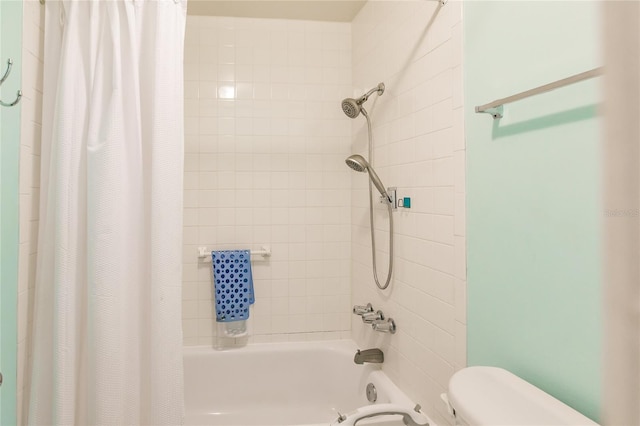 bathroom with toilet and shower / bath combo with shower curtain