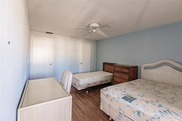 bedroom with ceiling fan and dark wood-type flooring