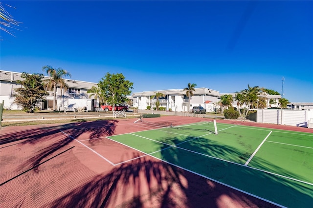 view of tennis court featuring basketball hoop