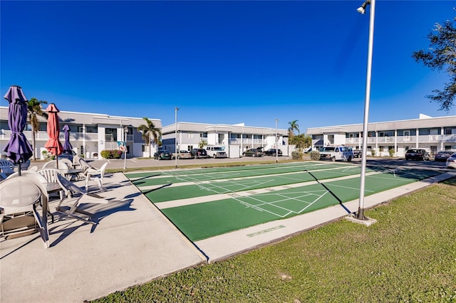 view of property's community with a lawn