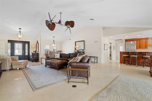 living room with ceiling fan and lofted ceiling