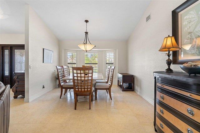 dining room featuring lofted ceiling