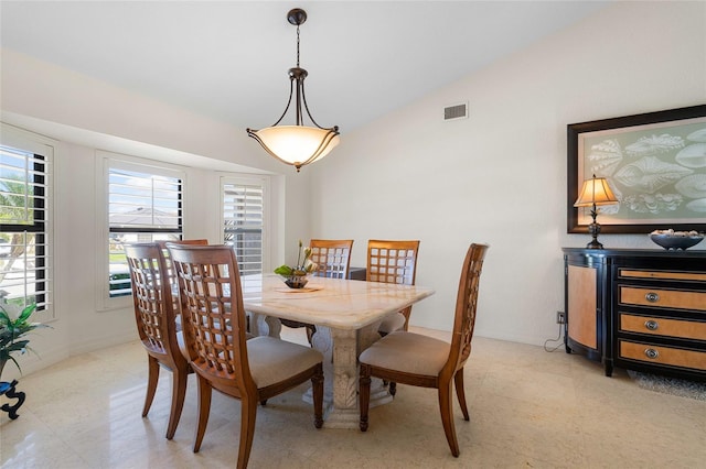 dining space featuring lofted ceiling