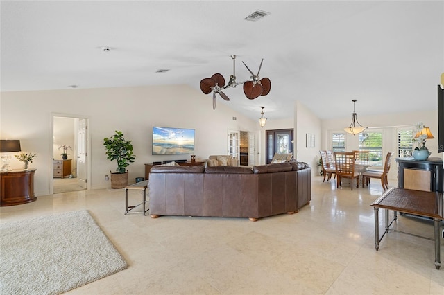 living room with lofted ceiling and a chandelier