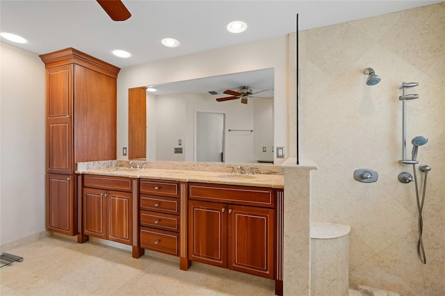 bathroom featuring a tile shower and vanity