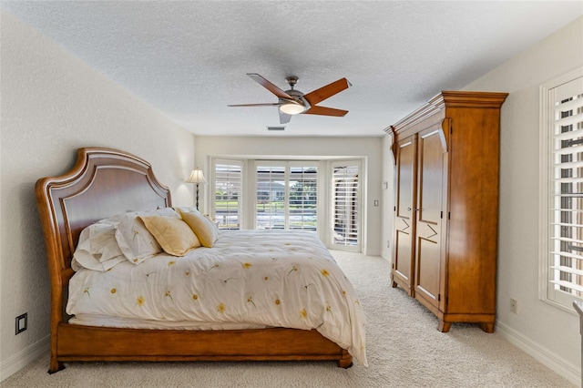 carpeted bedroom with ceiling fan, a textured ceiling, and access to outside