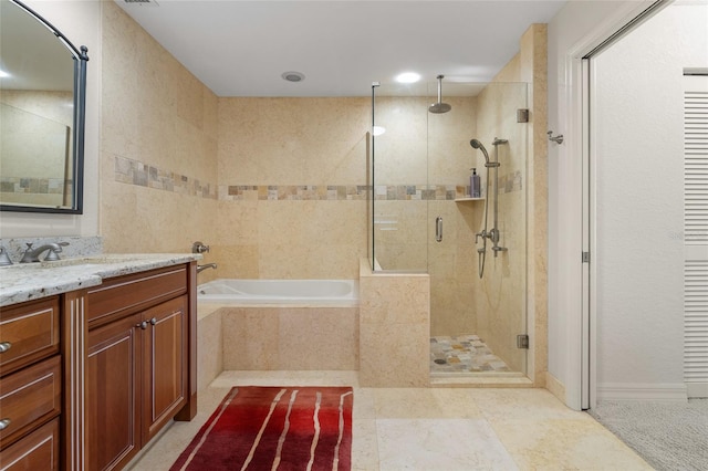 bathroom with vanity and independent shower and bath