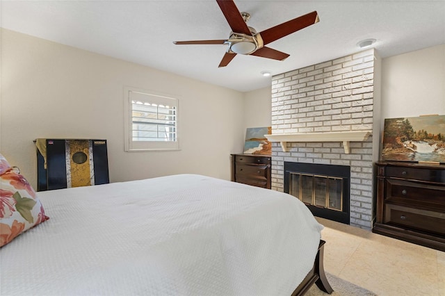 bedroom with a fireplace and ceiling fan