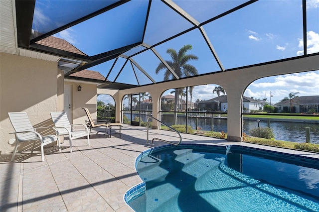 view of swimming pool featuring a lanai, a patio area, and a water view