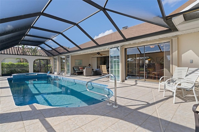 view of pool featuring ceiling fan, a lanai, a patio, and an in ground hot tub