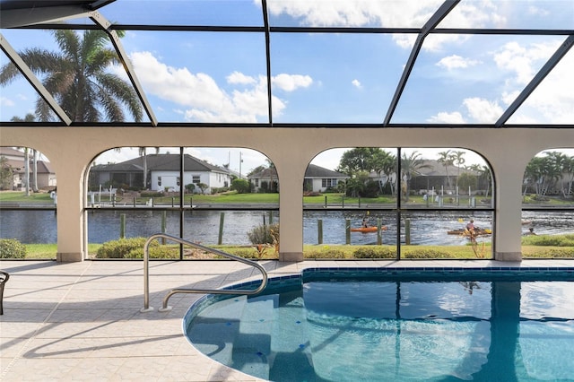 view of pool with a lanai, a water view, and a patio