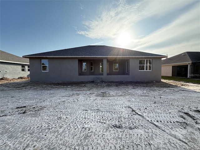 back of house with stucco siding