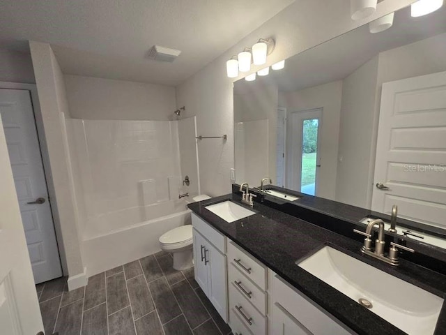 full bath with a sink, toilet, and wood tiled floor