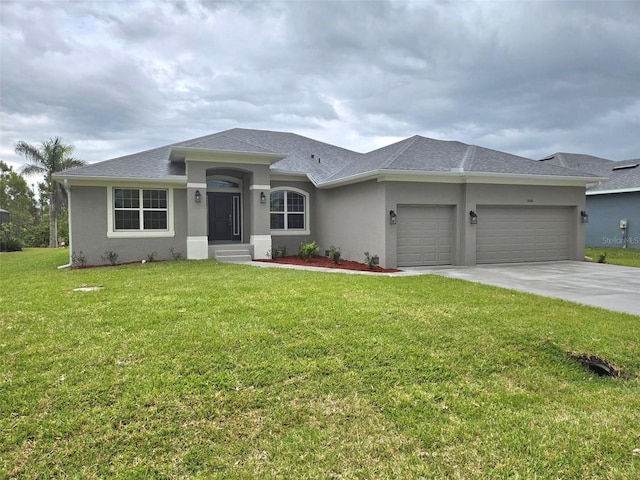 view of front of house featuring a garage, a front yard, concrete driveway, and stucco siding