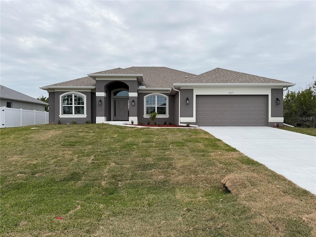 view of front facade with a garage and a front yard