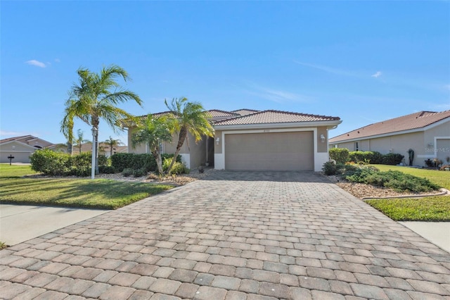 view of front of property with a front yard and a garage