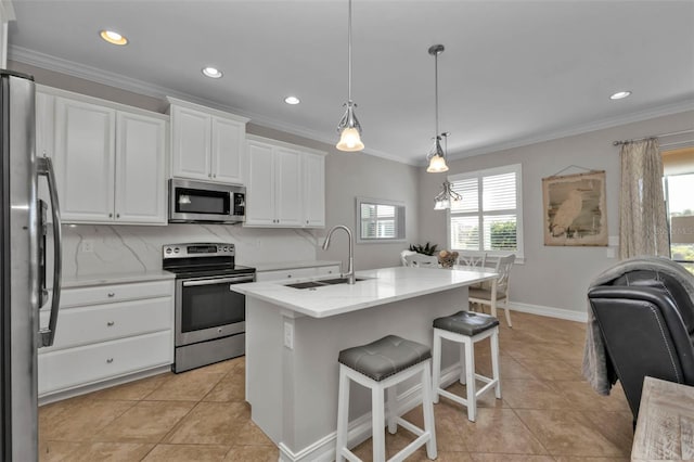 kitchen with sink, pendant lighting, a kitchen island with sink, white cabinets, and appliances with stainless steel finishes