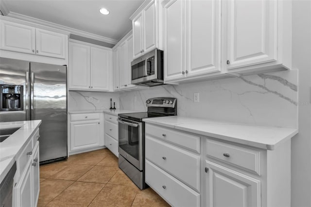 kitchen with white cabinetry, backsplash, and appliances with stainless steel finishes