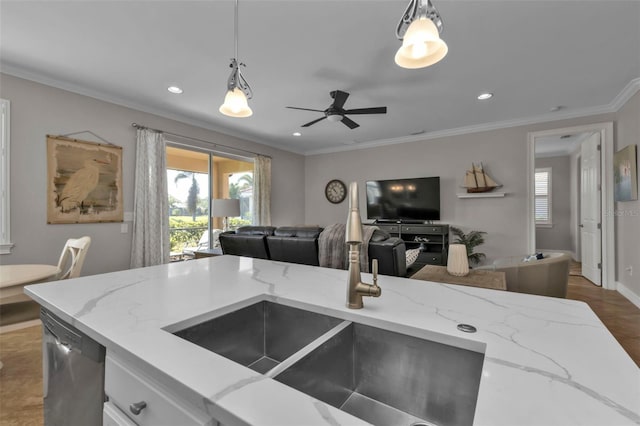 kitchen with dishwasher, decorative light fixtures, light stone countertops, and ornamental molding